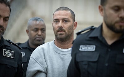 Pinhas Shem Tov Ran, a civilian security coordinator accused of shooting and seriously wounding a Palestinian woman in the West Bank, arrives at the Jerusalem District Court following his indictment, October 23, 2026. (Flash90)