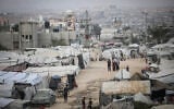 Palestinians are seen near their tents at a displacement camp in the central Gaza Strip, October 24, 2026. (Ali Hassan/Flash90)