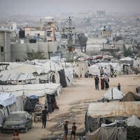 Palestinians are seen near their tents at a displacement camp in the central Gaza Strip, October 24, 2026. (Ali Hassan/Flash90)