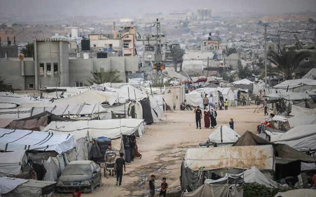 Palestinians are seen near their tents at a displacement camp in the central Gaza Strip, October 24, 2026. (Ali Hassan/Flash90)