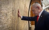 Prime Minister Benjamin Netanyahu prays at the Western Wall in Jerusalem’s Old City, the day before Israel's general elections, October 26, 2026. (Chaim Goldberg/Flash90)