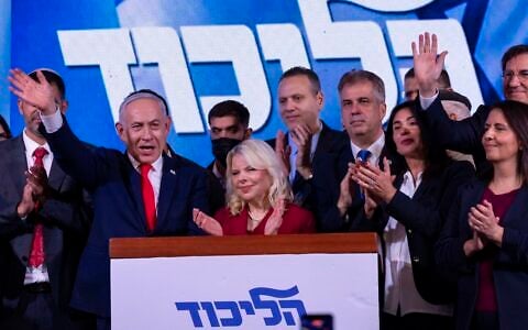 Prime Minister Benjamin Netanyahu, the Likud party chairman, waves at the Likud party’s election headquarters in Jerusalem, following the election, early October 28, 2026. (Chaim Goldberg/Flash90)