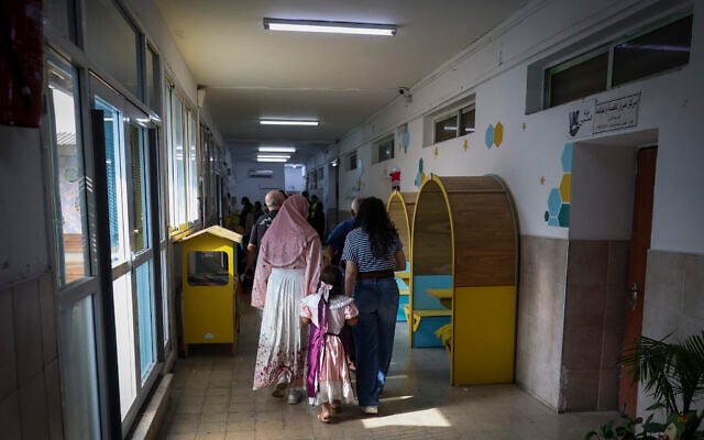 Illustrative: Arab Israelis arrive to cast their ballots at a polling station in Tayibe, October 27, 2026. (Jamal Awad/Flash90)