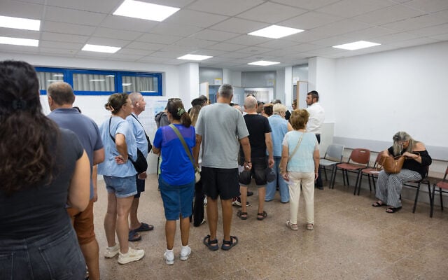 Israelis stand in line to cast their ballots at a polling station during the general election, October 27, 2026. (Liron Moldovan/FLASH90) Israelis stand in line to cast their ballots at a polling station during the general election, October 27, 2026. (Liron Moldovan/FLASH90)