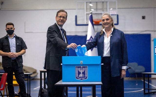 President Isaac Herzog and his wife Michal cast their ballots at a polling station in Jerusalem, during the election, October 27, 2026. (Yonatan Sindel/FLASH90)
