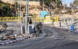 Israeli soldiers guard a checkpoint at the entrance to the West Bank city of Hebron, following a shooting attack in the area several days earlier, October 28, 2026. (Wisam Hashlamoun/Flash90)