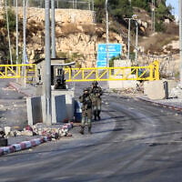 Israeli soldiers guard a checkpoint at the entrance to the West Bank city of Hebron, following a shooting attack in the area several days earlier, October 28, 2026. (Wisam Hashlamoun/Flash90)