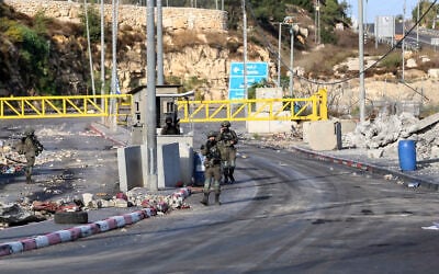Israeli soldiers guard a checkpoint at the entrance to the West Bank city of Hebron, following a shooting attack in the area several days earlier, October 28, 2026. (Wisam Hashlamoun/Flash90) Israeli soldiers guard a checkpoint at the entrance to the West Bank city of Hebron, following a shooting attack in the area several days earlier, October 28, 2026. (Wisam Hashlamoun/Flash90)