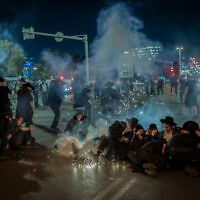 Ultra-Orthodox Jewish men block a road and clash with police during a protest against the jailing of yeshiva students who failed to comply with an army recruitment order, outside the city of Bnei Brak, October 29, 2026. (Flash90)