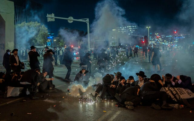 Ultra-Orthodox Jewish men block a road and clash with police during a protest against the jailing of yeshiva students who failed to comply with an army recruitment order, outside the city of Bnei Brak, October 29, 2026. (Flash90) Ultra-Orthodox Jewish men block a road and clash with police during a protest against the jailing of yeshiva students who failed to comply with an army recruitment order, outside the city of Bnei Brak, October 29, 2026. (Flash90)