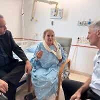 Democrats party chair Yair Golan (right) and MK Gilad Kariv (left) visit photojournalist Heidi Levine, who was attacked in the West Bank on October 16, in the hospital on October 18, 2026.