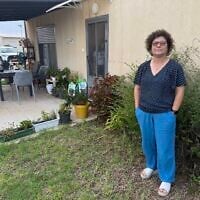 Idit Etinger of Kibbutz Kfar Aza, outside her temporary home in Kibbutz Ruhama, southern Israel, October 5, 2026. (Sue Surkes/Times of Israel)