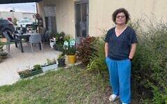 Idit Etinger of Kibbutz Kfar Aza, outside her temporary home in Kibbutz Ruhama, southern Israel, October 5, 2026. (Sue Surkes/Times of Israel)