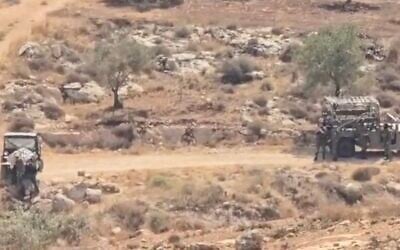 Settlers are filmed stealing from Palestinian olive trees as IDF soldiers look on in the central West Bank village of al-Mughayyir on October 1, 2026. (Screen capture/X) Settlers are filmed stealing from Palestinian olive trees as IDF soldiers look on in the central West Bank village of al-Mughayyir on October 1, 2026. (Screen capture/X)