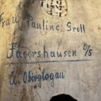 The reverse side of a Torah scroll fragment offered for auction in Norway, bearing a handwritten German address. The auction house claimed the parchment had been used by SS soldiers to wrap a package sent to Germany during the Holocaust. (Courtesy of RUTH: Remember Us The Holocaust, via JTA)