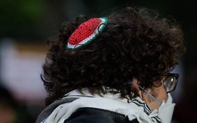 A person wears a watermelon-style kippah, a symbol of solidarity with Palestinians. (Paul Frangipane / AFP / Getty Images via JTA)
